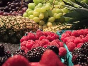 Fresh berries and tropical fruits at a farmers market display