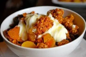 Cereal with milk and dried fruit in a white bowl