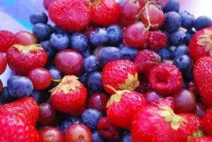 Fresh raspberries, blueberries, and red currants clustered together
