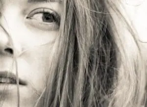 Close-up black and white portrait of a woman with long straight hair