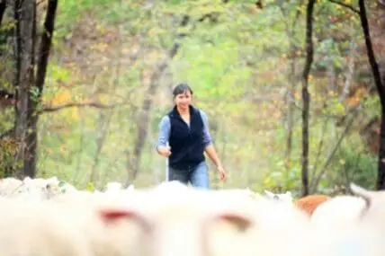 Jacqueline Smith jogging through a wooded path on her farm