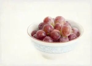Red grapes in a decorative blue and white bowl