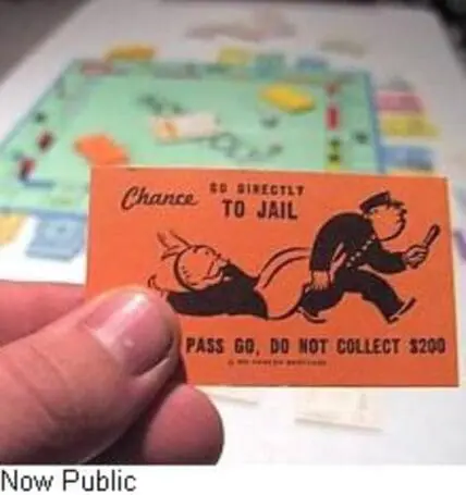 Go Directly to Jail" card from Monopoly board game held in hand