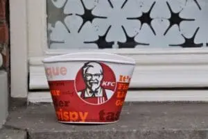 KFC bucket placed on a doorstep next to a window