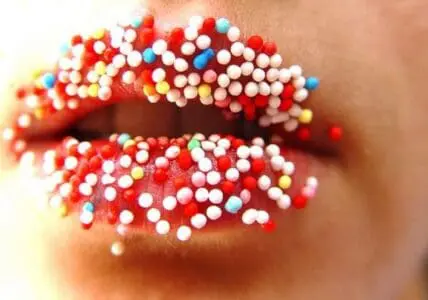 Colorful beads covering red lips and mouth area