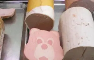 Various packaged meat products displayed in containers