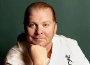 Mario Batali in white chef's jacket against green background