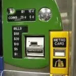 Green fare machine accepting coins and bills for NYC subway metro card