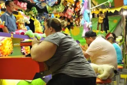 Woman playing a carnival game at a fair or arcade