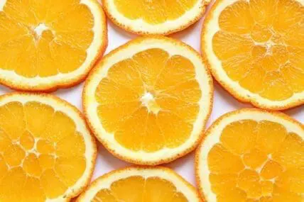 Sliced oranges arranged on a white background