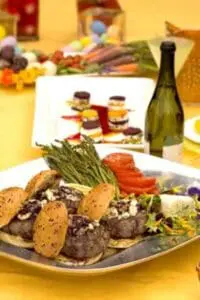 Gourmet beef tacos with asparagus and red peppers served with wine