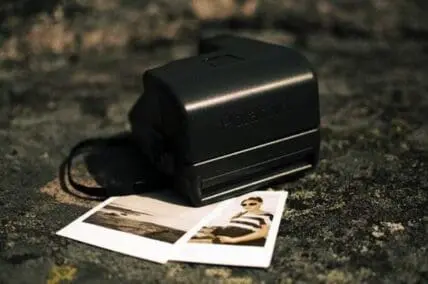 Instant camera with developed photos on textured surface