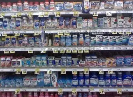Shelves of antacid and digestive aid products in a pharmacy or grocery store