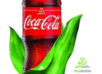 Coca-Cola bottle with green plant leaves and PlantBottle logo