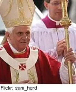 Pope in white and red vestments with gold ceremonial staff