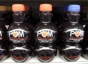 Bottles of POM Wonderful pomegranate cherry juice displayed on a shelf