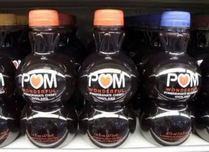 Bottles of POM Wonderful pomegranate cherry juice displayed on a shelf