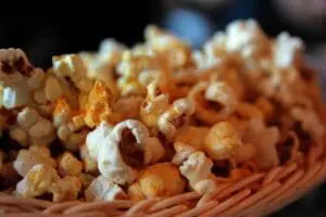 Freshly popped buttered popcorn in a striped container