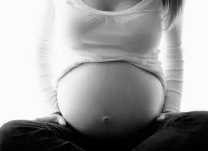 Pregnant woman's belly in black and white photograph