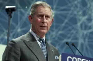 Prince Charles speaking at a podium with microphones