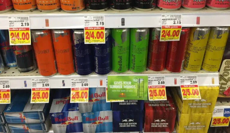 image of grocery shelves stocked with Red Bull and other energy drinks and the ingredients of Red Bull, one energy drink might not be any safer or better than the other.