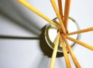 Wooden skewers tied with twine inserted into a glass jar for DIY essential oil diffuser
