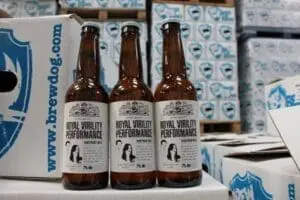 Three bottles of Royal Virility Performance beer in front of brewery boxes