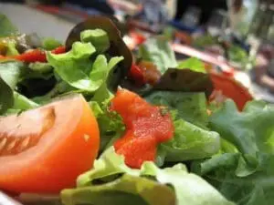 Fresh salad with tomato slices and mixed greens