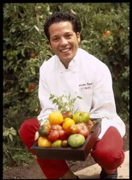 Marino holding a basket of fresh vegetables in a garden