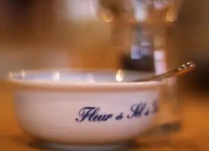 Decorative bowl labeled "Fleur de Sel" with salt and spoon
