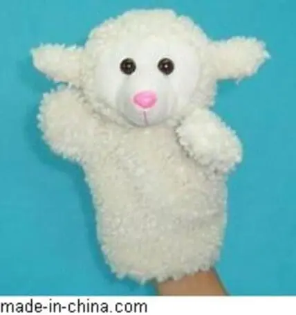 White plush puppet with pink nose and black eyes on blue background