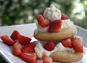 Strawberry shortcake with whipped cream on a white plate
