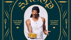 Snoop Dogg holds a plate of mac and cheese on a cookbook cover titled "Tha Boss Dogg's Kitchen
