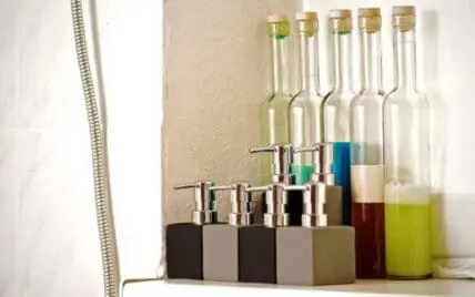 Various cosmetic products and ingredients in bottles and dispensers on a shelf