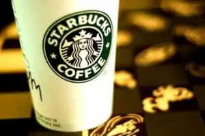 Starbucks coffee cup with logo surrounded by coffee beans