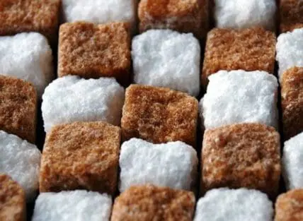 Close-up of white and brown sugar cubes arranged in a checkered pattern