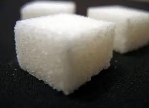 Sugar cubes on dark surface