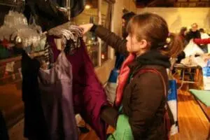 Child examining clothing at a community swap or clothing exchange event