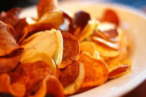 Crispy baked sweet potato chips on a white plate