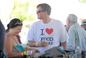 Man wearing "I Love Food" shirt at outdoor food festival event