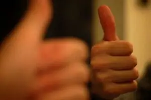 Two thumbs-up gestures showing approval and positivity