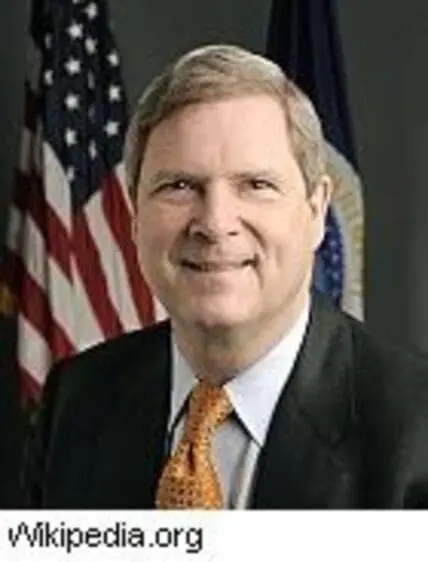 U.S. Secretary of Agriculture in official portrait with American flag