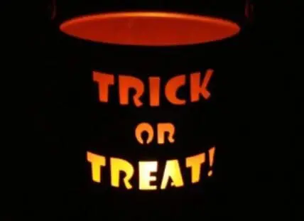Glowing jack-o'-lantern bucket with "Trick or Treat" text on black background