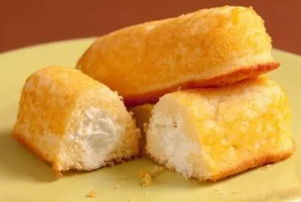Golden sponge cake with creamy filling on yellow plate
