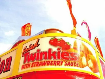 Colorful carnival sign advertising Twinkies with strawberry sauce and fresh strawberries