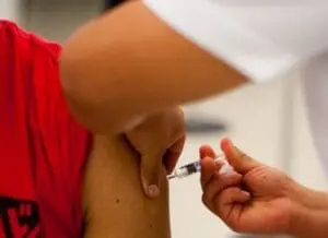 Close-up of a person receiving a vaccine injection in the arm