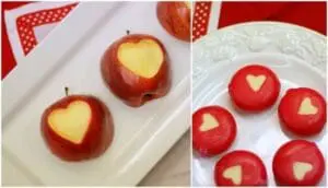 Apples with heart-shaped cutouts and tomatoes with heart designs for Valentine's Day snacks