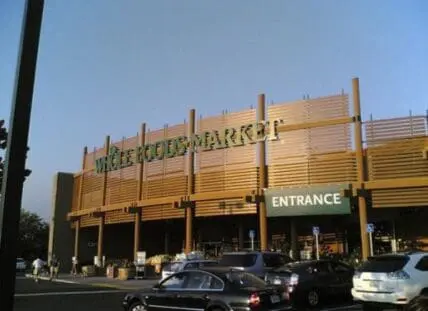 Whole Foods Market storefront with yellow wooden facade and entrance