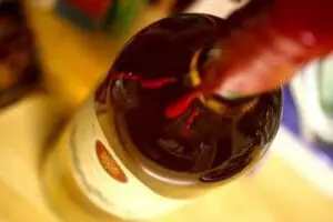Dark red wine being poured into a glass
