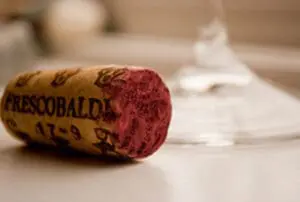 Wine cork with "Frescobaldi" label next to an empty glass
